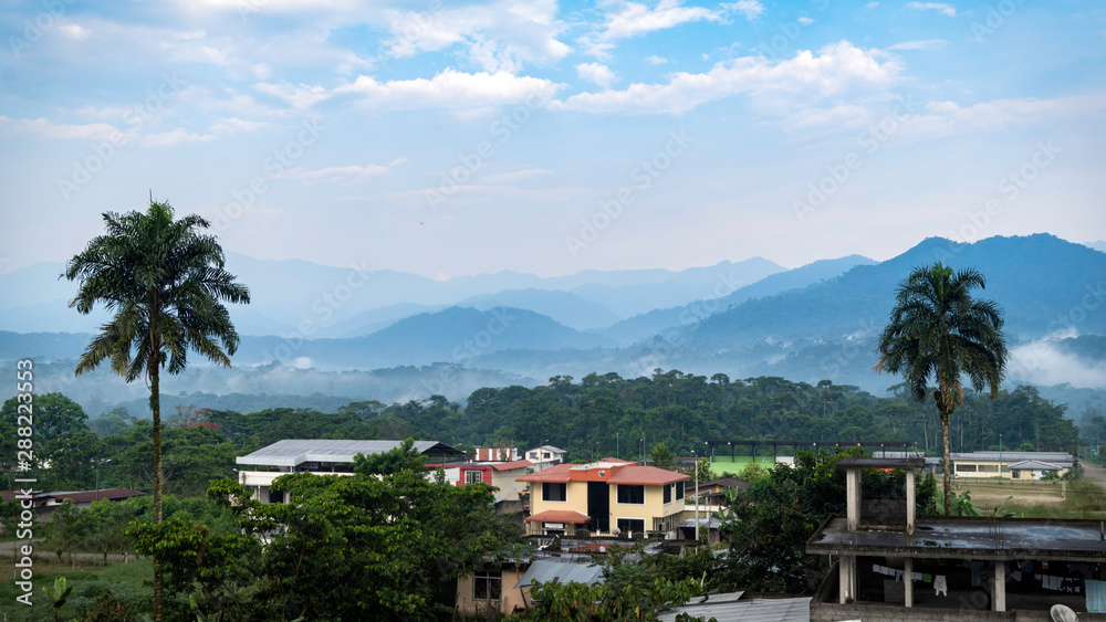 neighborhoods characteristic of the amazons in ecuador. you can see the mountains full of vegetation and the morning fog