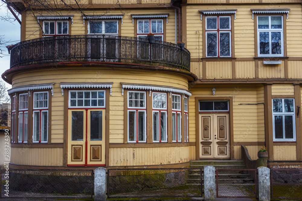 Details of the large old wooden yellow building in historical center of Parnu, Estonia.