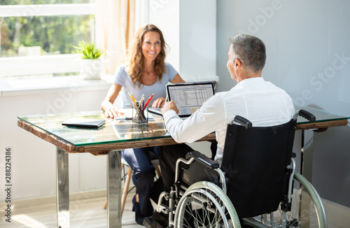Disabled Businessman Working On Laptop