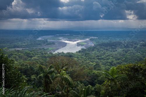 Amazonian viewpoint called Indichuris, lanscape located in Ecuador. The confluence of the Pastaza and Puyo rivers, a dense vegetation and a sky covered with large clouds can be appreciated. photo
