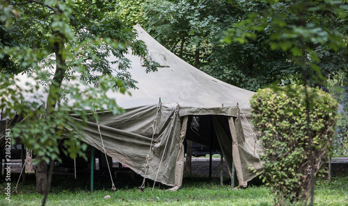 camouflaged green military tent in the forest