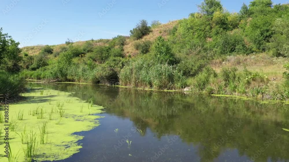Wildlife of Russia: a small river among hills and meadows on a summer day Wildlife of Russia: a small river among hills and meadows on a summer day