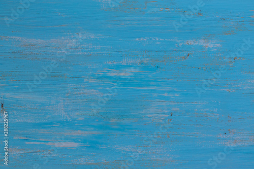 Background in the form of a wooden surface painted in blue with light spots with a horizontal texture
