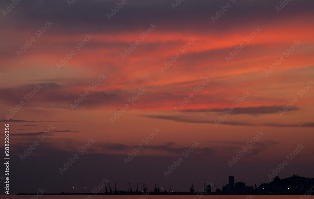 Sunset glow clouds in form of Ukraine map silhouette sky
