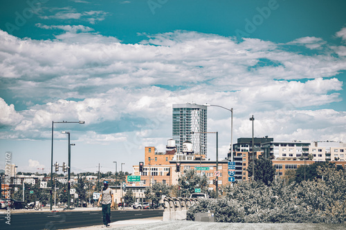 Urban lifestyle in the Denver city of Colorado state. Downtown district on a sunny day with beautiful sky. Amazing buildings in the heart of Denver. © Regina Foster