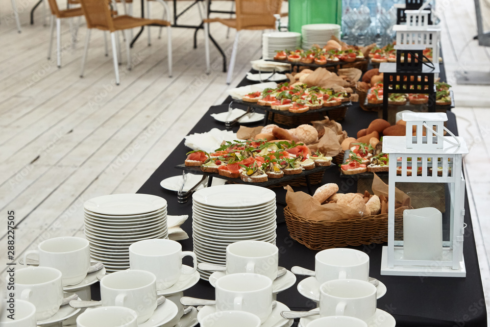 Catering. Snacks for guests of the holiday on tables in the tent. Stock