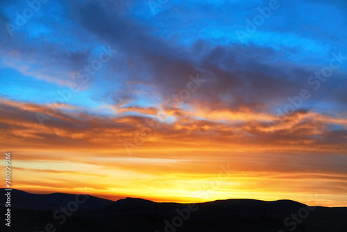 Land with and dramatic colorful sky at sunset