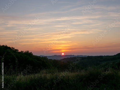 sunset over green field