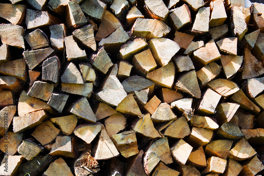 a lot of firewood outdoor, brown background a lot of firewood outdoor, brown background