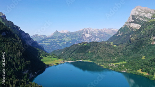 Klöntalersee lake in mountains. Kanton Glarus, Switzerland. Aerial view.