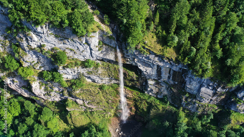 Aerial view of waterfalls in mountains, Klöntalersee lake, Glarus Kanton, Switzerland.