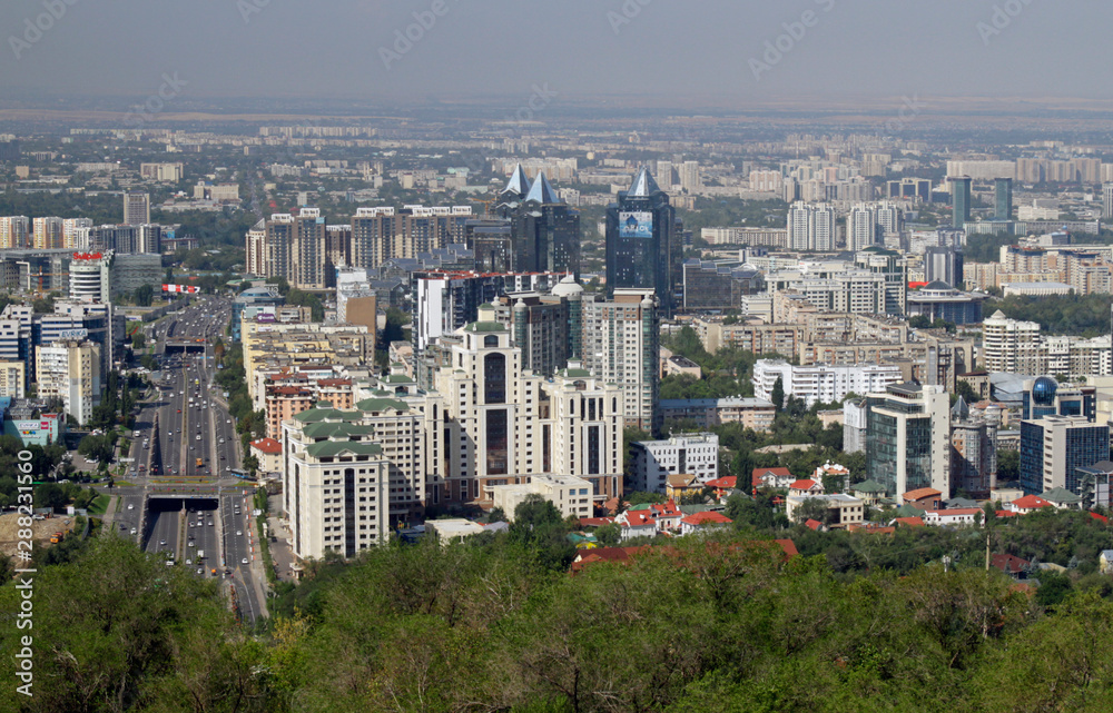 Almaty, Kazakhstan - August 24, 2019: View over the skyline of Almaty with slight smog clouds over the city.