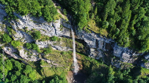 Fototapeta Naklejka Na Ścianę i Meble -  Aerial view of waterfalls in mountains, Klöntalersee lake, Glarus Kanton, Switzerland.