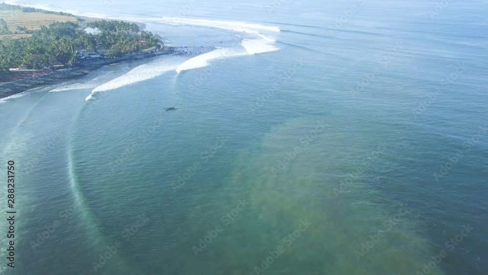 custom made wallpaper toronto digitalAERIAL 4K Fly over a single fishing boat returning to beach with surfers riding waves in the distance