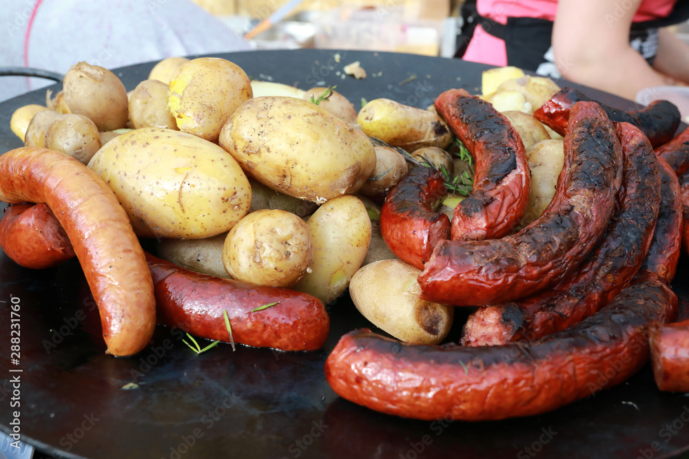 Cooking potatoes and sausages Cooking potatoes and sausages