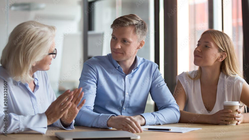 Young couple have talk with female consultant at office Young couple have talk with female consultant at office