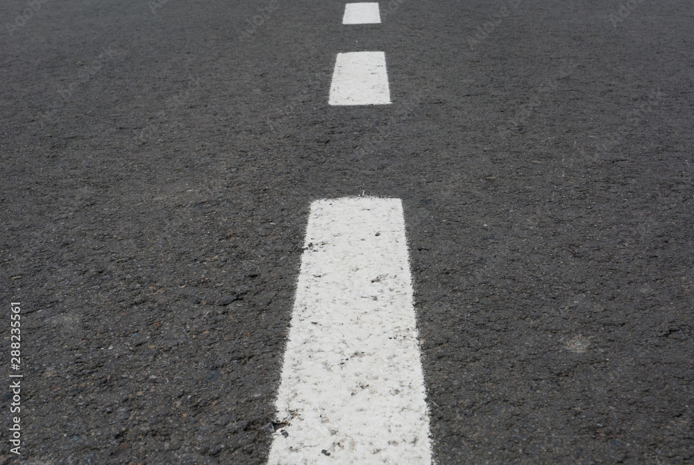 Dark asphalt road with marking lines. Tarmac texture Dark asphalt road with marking lines. Tarmac texture