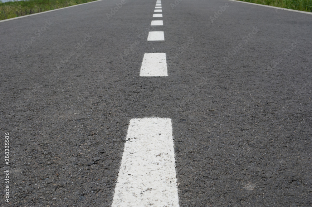 Dark asphalt road with marking lines. Tarmac texture Dark asphalt road with marking lines. Tarmac texture