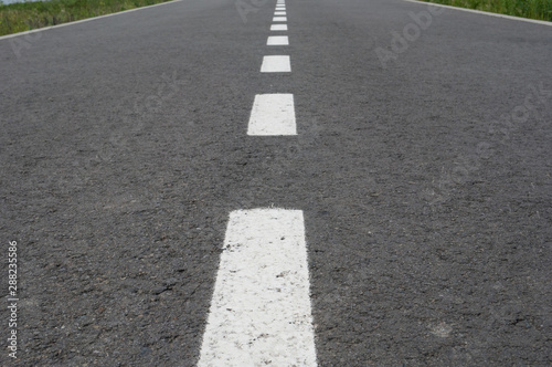 Wallpaper Mural Dark asphalt road with marking lines. Tarmac texture Torontodigital.ca