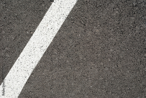 New asphalt texture with white line. Top view © YanaKho