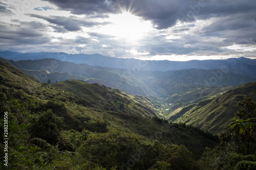 Beautiful mountainous field reflected by the sun. In the center an extensive valley covered with vegetation. South America photo