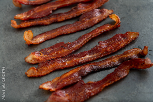 Cooked Bacon Stripes on Dark Background