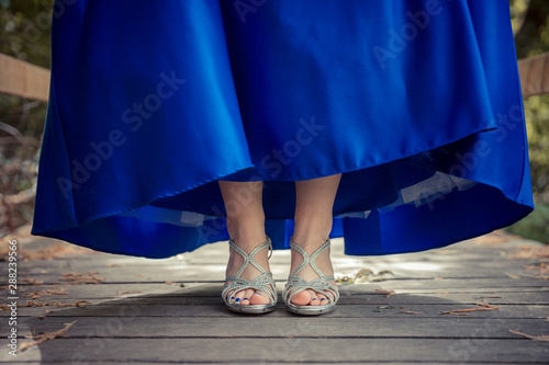 A fancy blue dress with sparkly shoes 