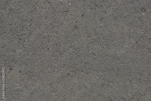 Smooth asphalt road. Tarmac dark grey grainy road background. Top view grunge rough surface