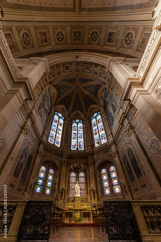 Obraz premium Inner view of the Saint Trinity church in Paris, illuminated by the early autumn light through the tainted glasses