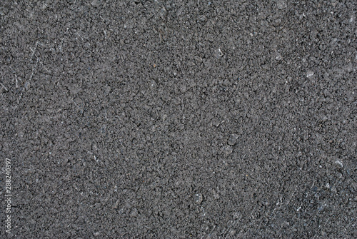 Smooth asphalt road. Tarmac dark grey grainy road background. Top view grunge rough surface