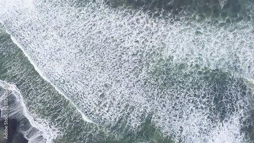 AERIAL 4K Revealing shot of Medewi point break on sunny day