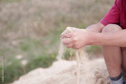 little boy playing with sand on the beach stock photo © herlanzer