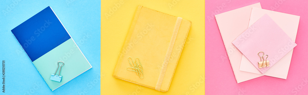 Panoramic shot of yellow and blue notepads near pink sheets of paper on tricolor background