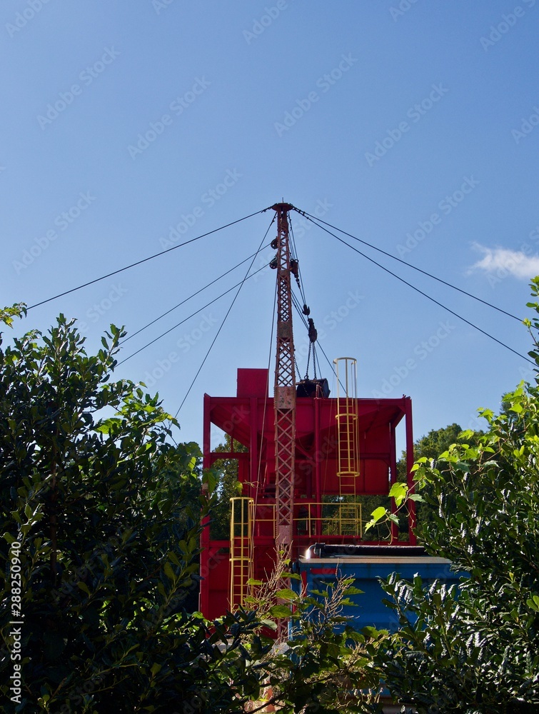 A red and yellow crane for gravel distribution A red and yellow crane for gravel distribution