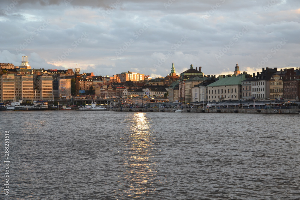sunlight road on the sea waves leads to another shore of Stockholm's Strommen