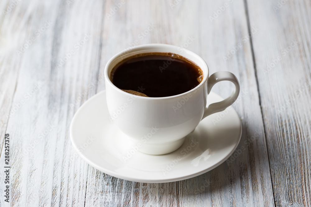 White coffee Cup on light wooden background White coffee Cup on light wooden background
