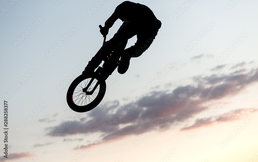 BMX cyclist training in a late afternoon BMX cyclist training in a late afternoon