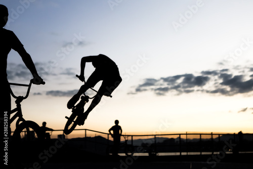 BMX cyclists training in a late afternoon in black and white