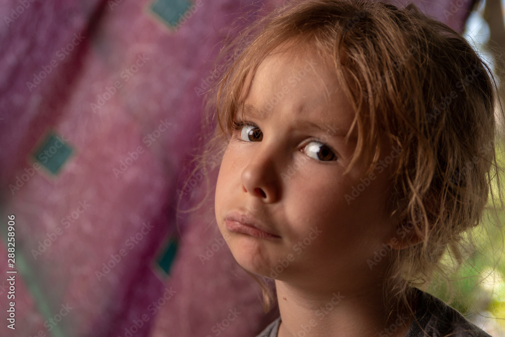 Young girl posing for camera on purple background Young girl posing for camera on purple background