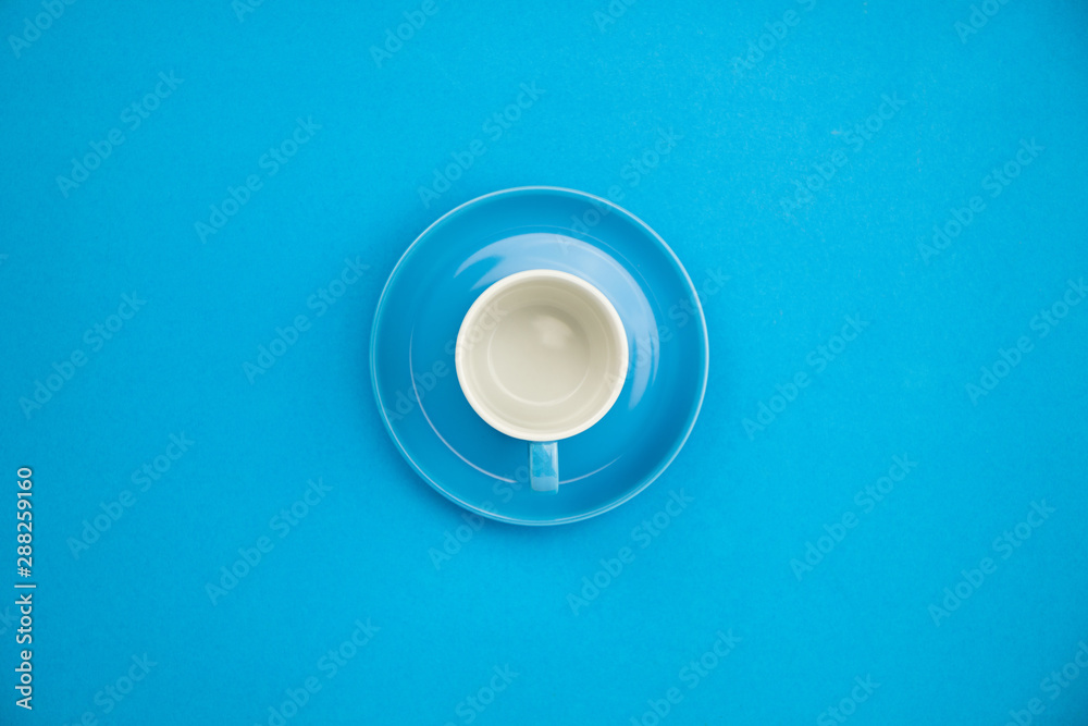 Colorful coffee cup on blue paper background Colorful coffee cup on blue paper background