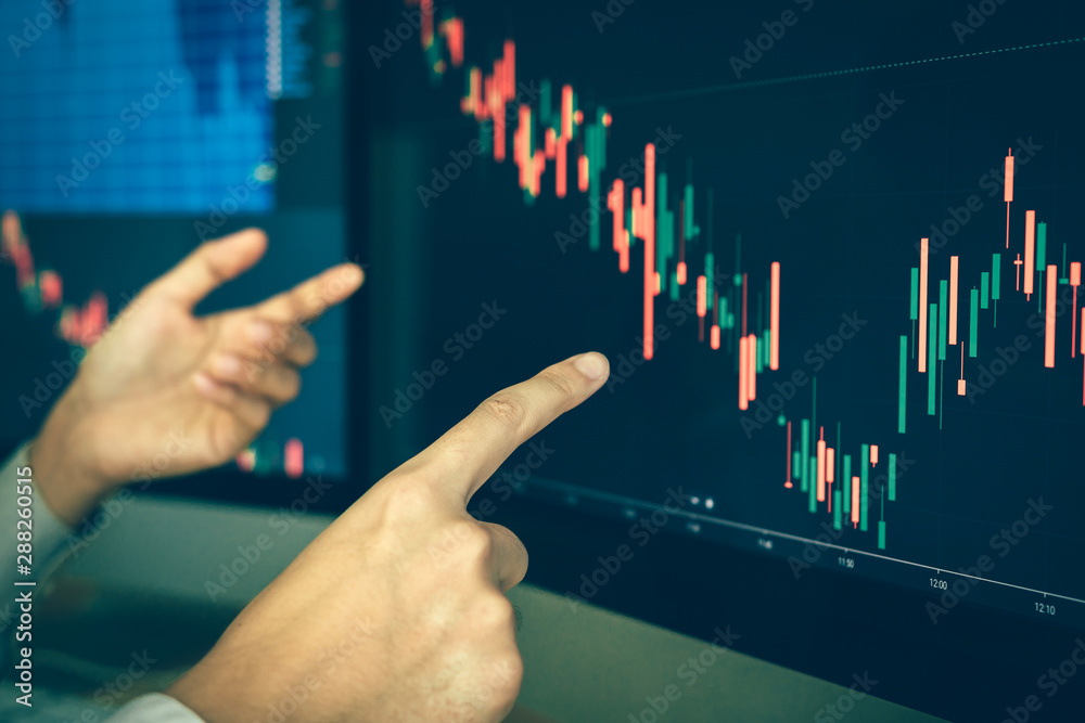 Team of agent trading business people pointing graph and analysis stock market on computer screen in office. Team of agent trading business people pointing graph and analysis stock market on computer screen in office.