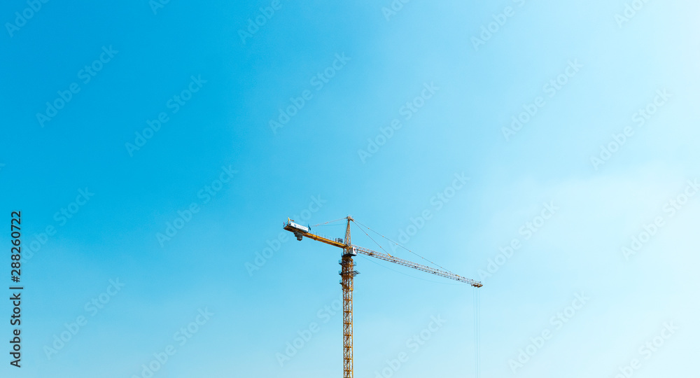 Industrial landscape with silhouettes of cranes on the sunset background Industrial landscape with silhouettes of cranes on the sunset background