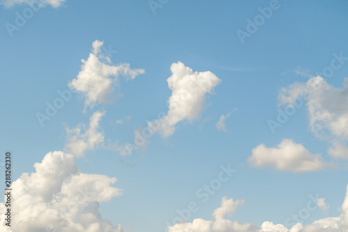 White powerfully cumulus clouds on a blue sky.