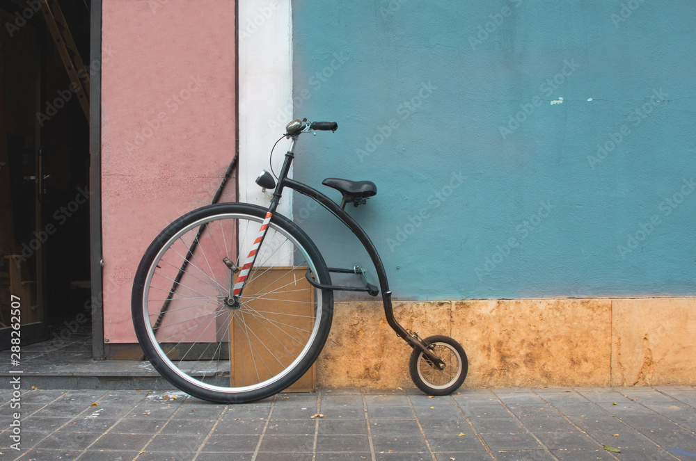 Penny Farthing bicycle mountain model leaning on a blue wall. Penny Farthing current model Stock Photo Adobe Stock