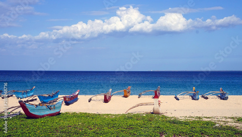 Colourful fishing boats on Dutch Bay beach in Trincomalee, Sri Lanka