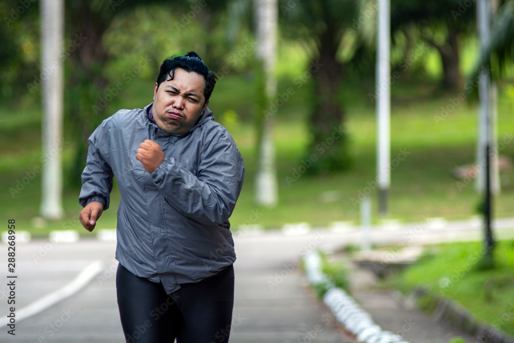 portrait of Fat man feeling tired to jogging in park. He need to lose weight portrait of Fat man feeling tired to jogging in park. He need to lose weight