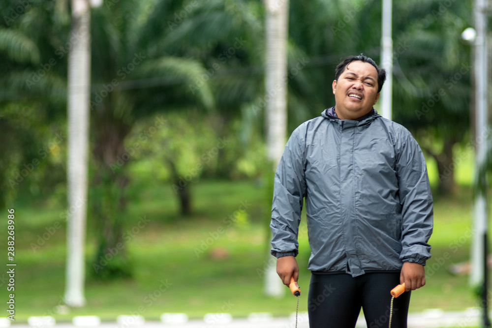 fat obese man doing exercises with jumping rope overweight guy training workout weight loss fat obese man doing exercises with jumping rope overweight guy training workout weight loss