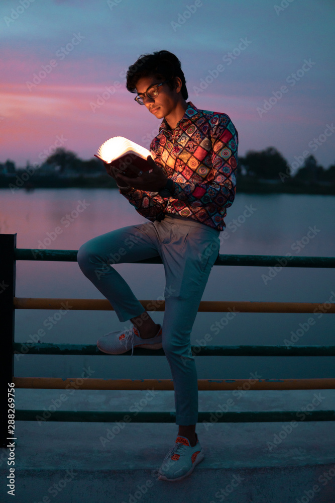 person reading a book in nature