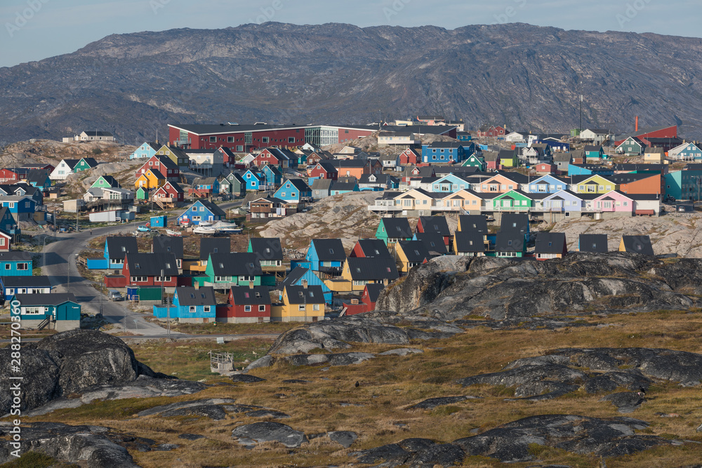The colorful houses of Rodebay, Greenland. This settlement is located on a small peninsula jutting off the mainland into eastern Disko Bay. Sunny day in summer season. Unesco world heritage.