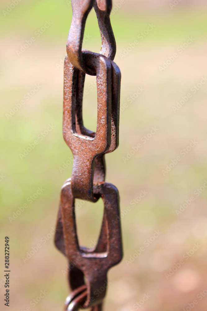 links of a rusty old chain on a blurred background. links of a rusty old chain on a blurred background.
